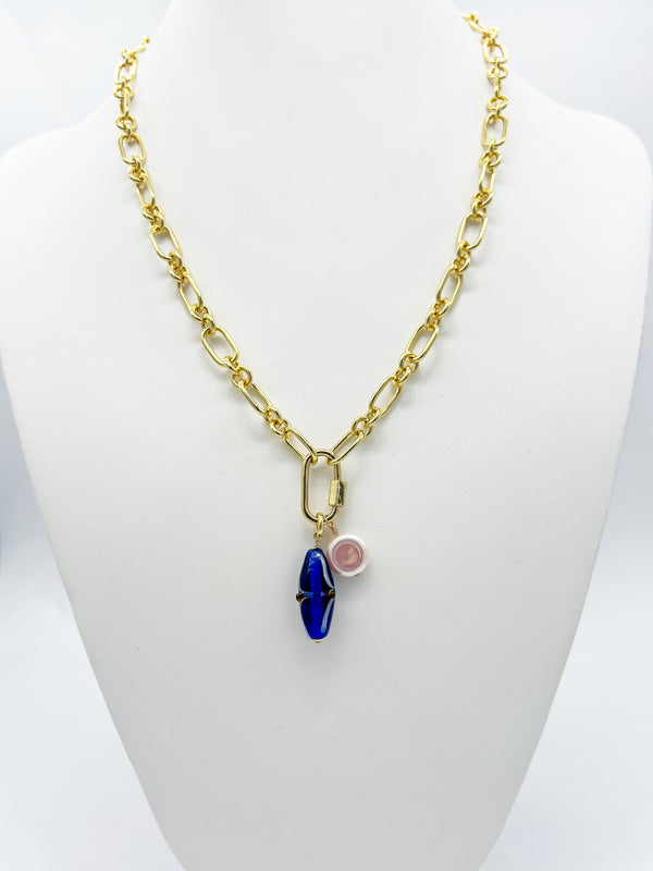 14k gold-filled link necklace with a screw carabiner clasp, featuring a blue glass charm and a flat coin pearl, displayed on a white background.