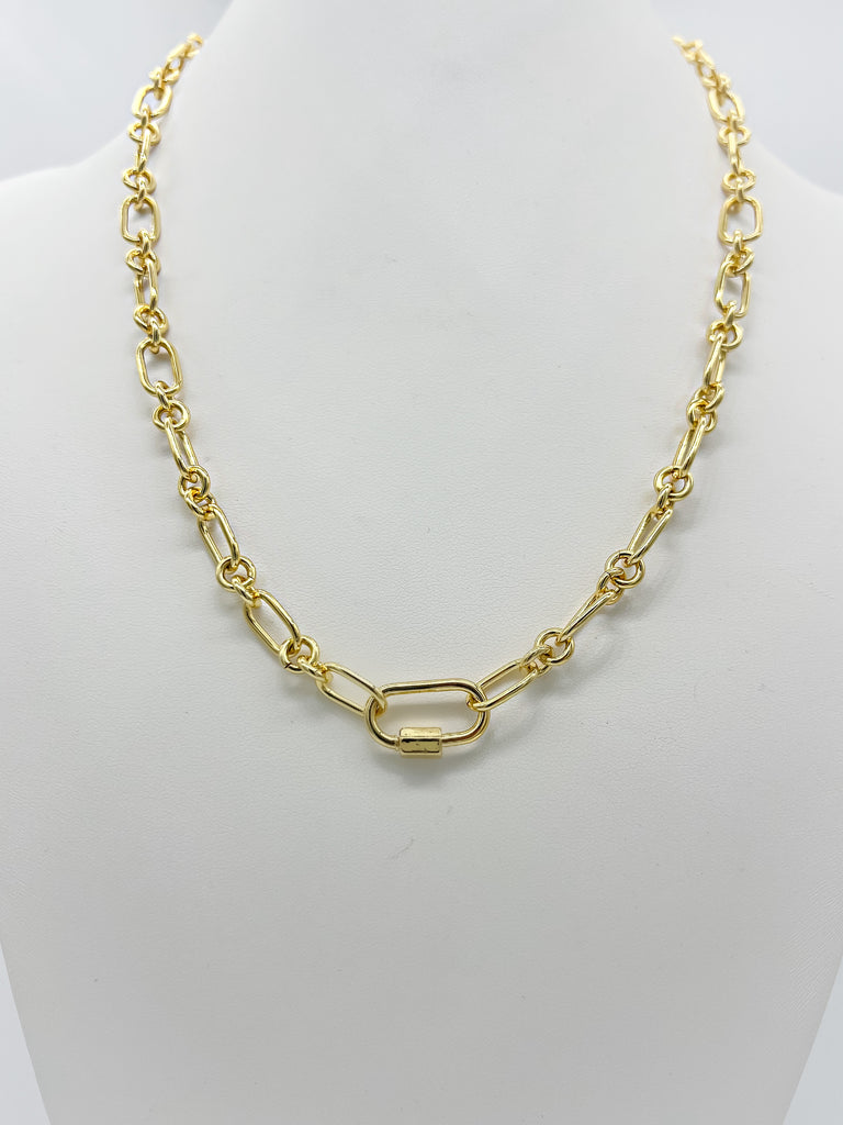 Golden Link necklace featuring alternating long and short links with a central carabiner screw clasp, displayed horizontally on a white background.