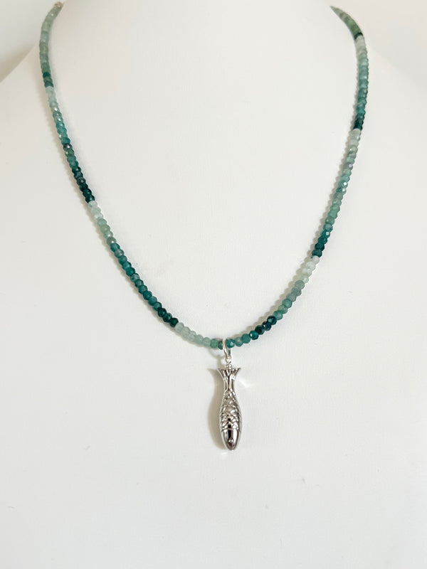 Green ombre grandidierite crystal necklace with a sterling silver fish charm displayed on a white background.