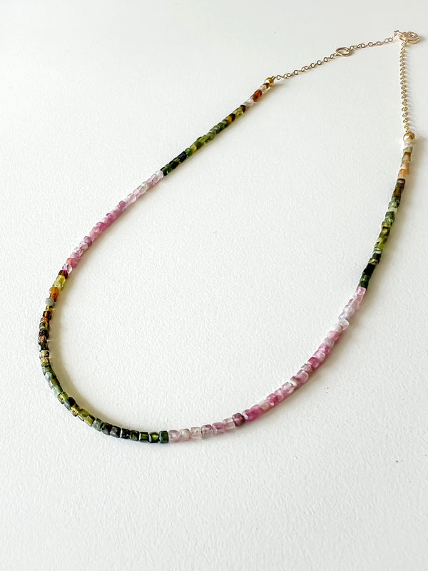 Pink and green tourmaline beaded necklace made with fine crystal beads and 14k gold-filled details, displayed on a white background.