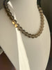 12 mm round smoky quartz strand necklace displayed on a white jewelry bust with sunlight highlighting the beads.